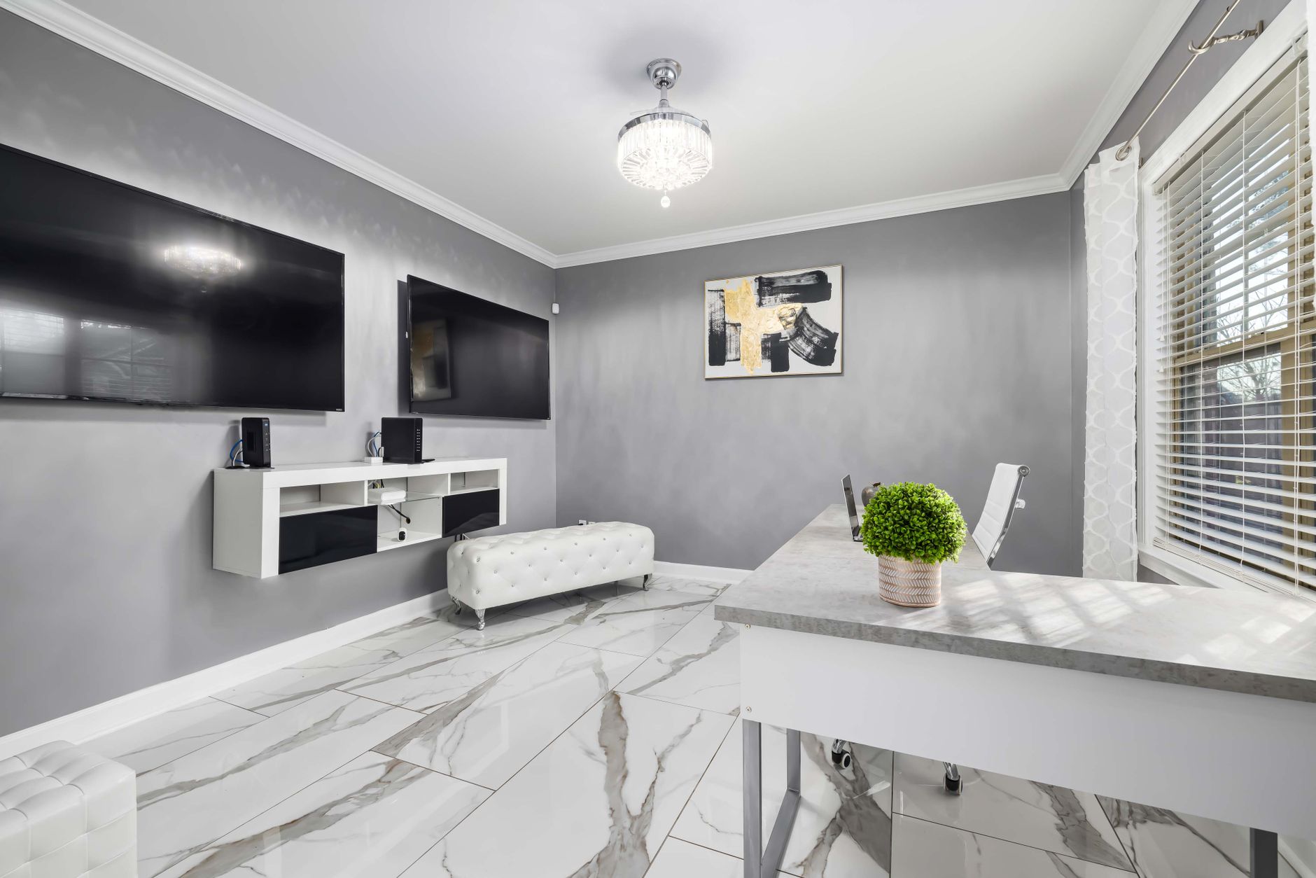 Stylish living room featuring dual wall-mounted televisions and elegant decor.