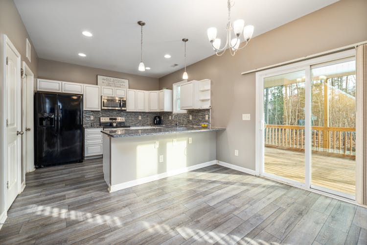 Open Floor Plan With Kitchen And Balcony Doors