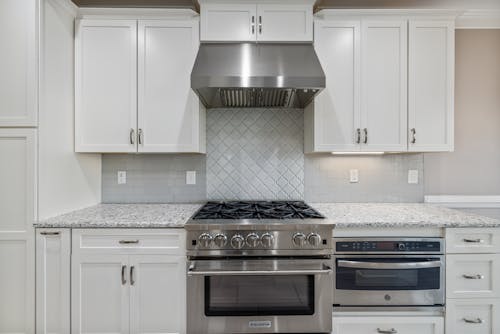 White Wooden Kitchen Cabinet over White Gas Range Oven