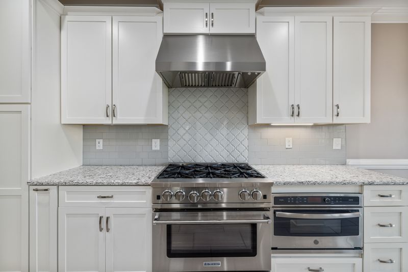 Stainless steel oven range built into a kitchen