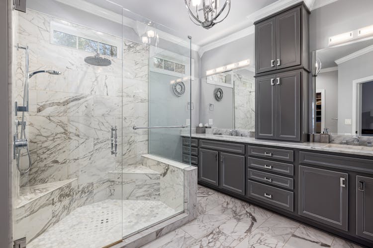 Bathroom With Dark Cabinets And Spacious Shower