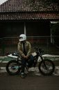 Man in Brown Jacket Riding Motorcycle