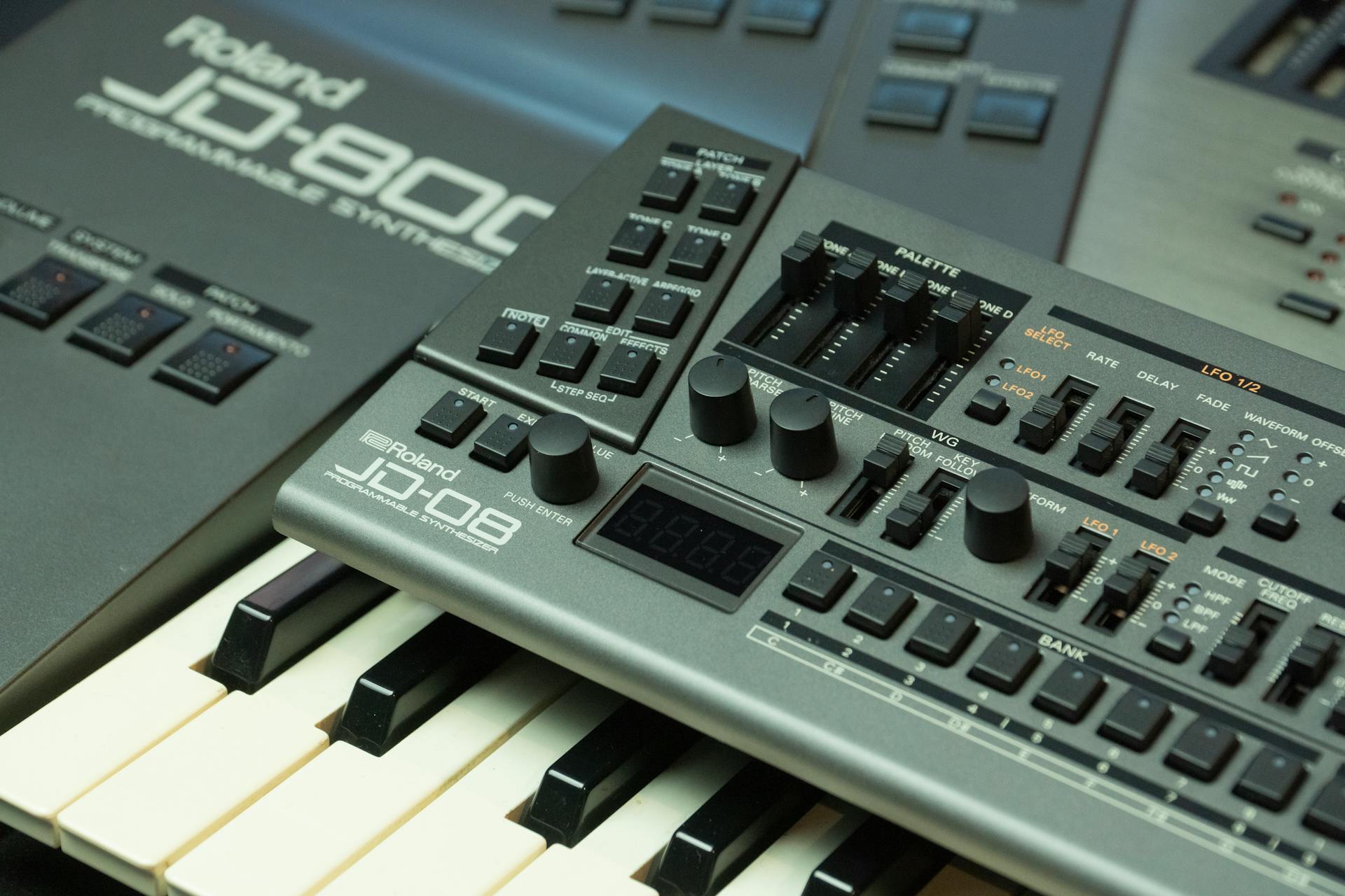 Detailed view of a Roland JD-800 synthesizer showing control knobs and keyboard.