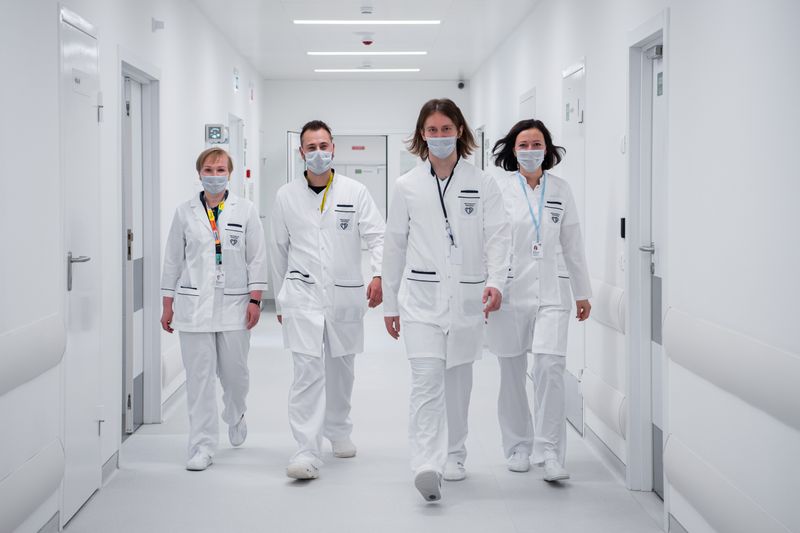 Clinical staff walking in a hospital corridor