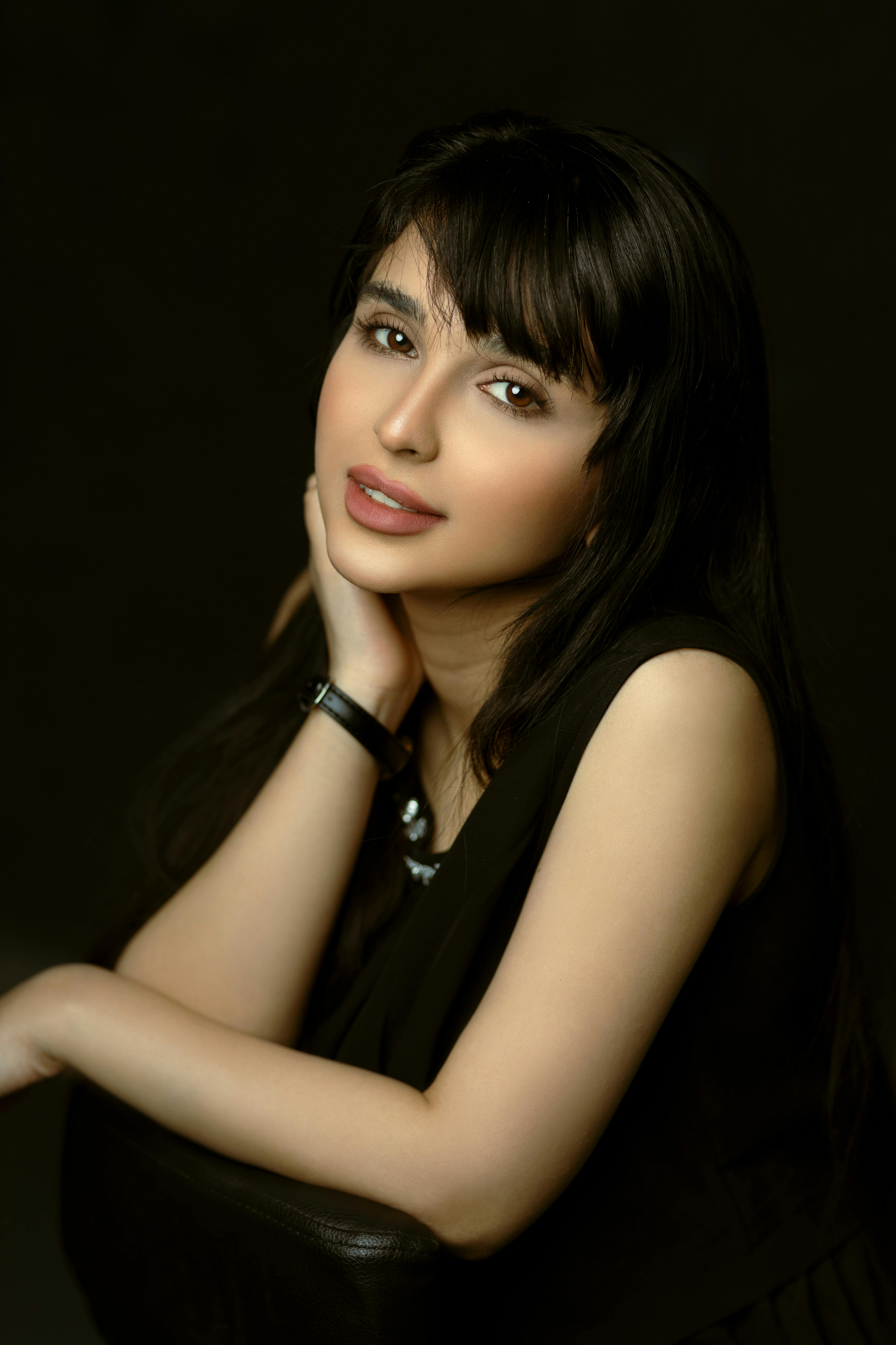 portrait of smiling woman on black background