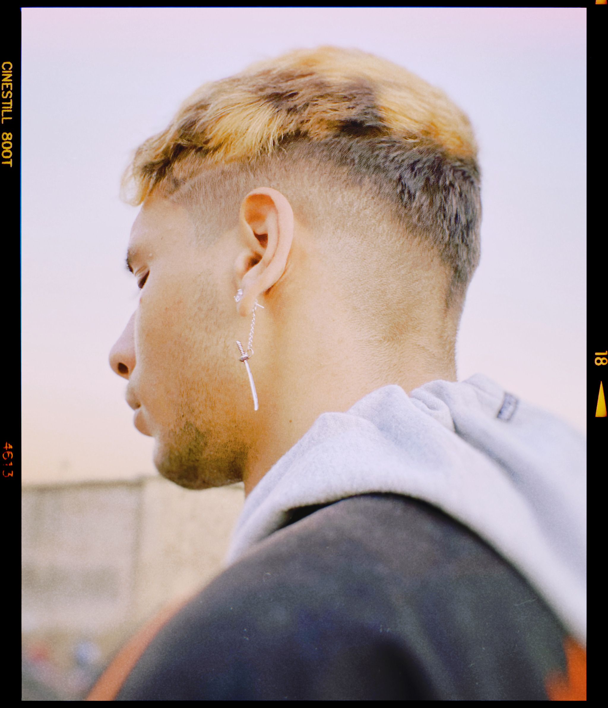 Close-up portrait of a man with an earring in Fes, Morocco, showcasing urban style.