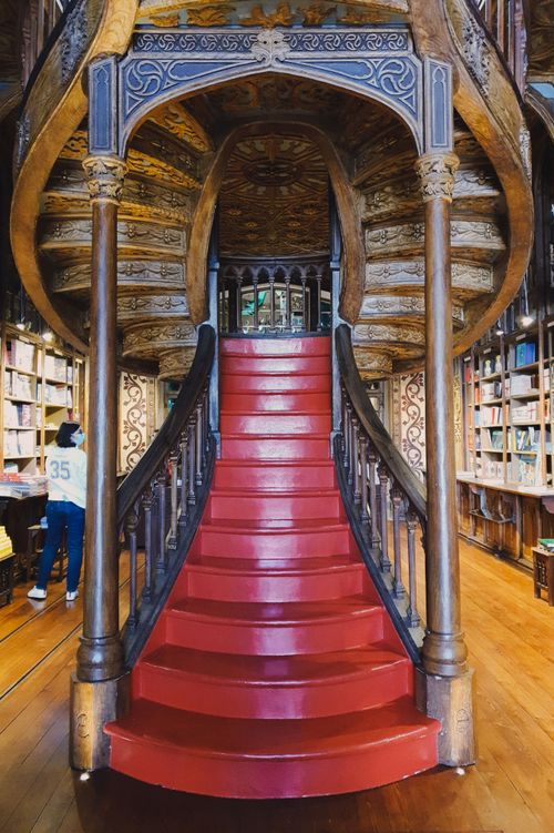 Free Intricate wooden staircase in Lello Bookstore, Porto, a masterpiece of architectural design. Stock Photo