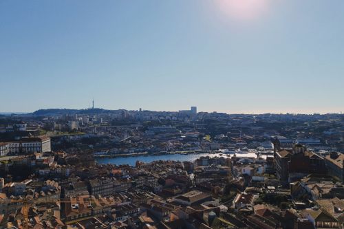 Free Stunning aerial view of Porto, Portugal showcasing the river Douro and the city's skyline under a clear blue sky. Stock Photo