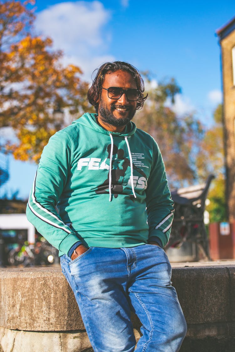 Smiling Man In Green Sweatshirt