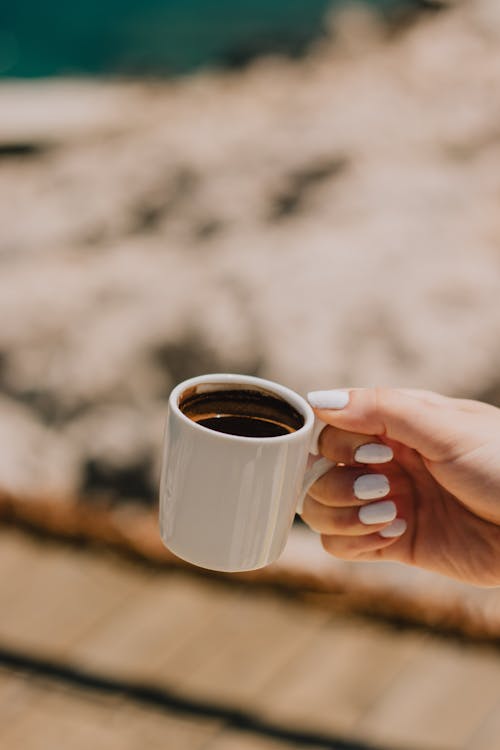 Free Close-up View of Hand Holding Coffee Cup Stock Photo