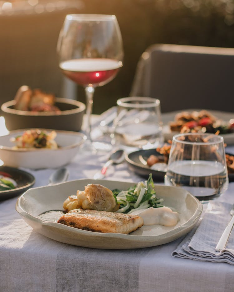 Gourmet Dinner Served On White Tablecloth