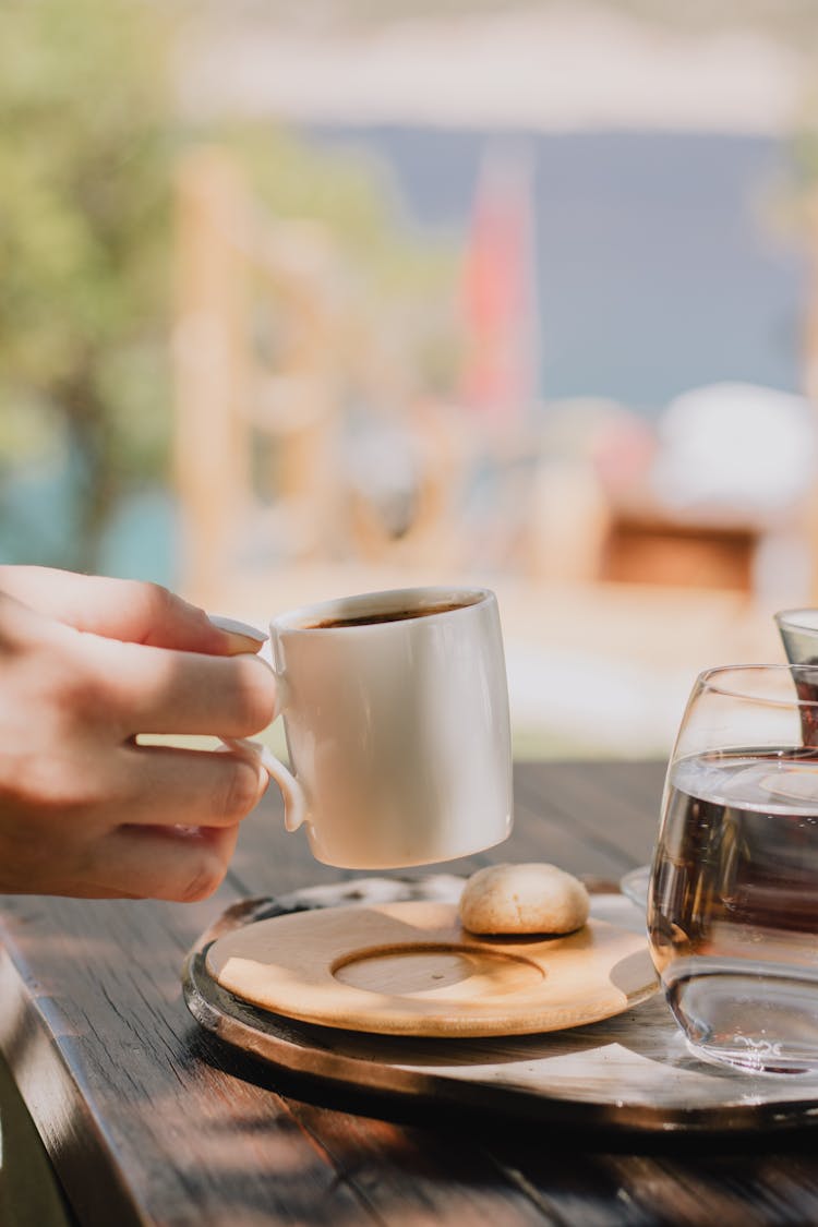 Hand Picking Up Cup Of Coffee