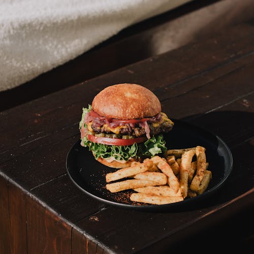 Burger and French Fries on Black Plate