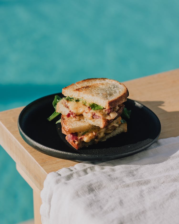 Grilled Sandwich Stack On Table By Pool