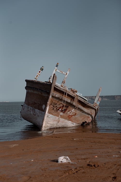 A Broken Wooden Boat on the Shore