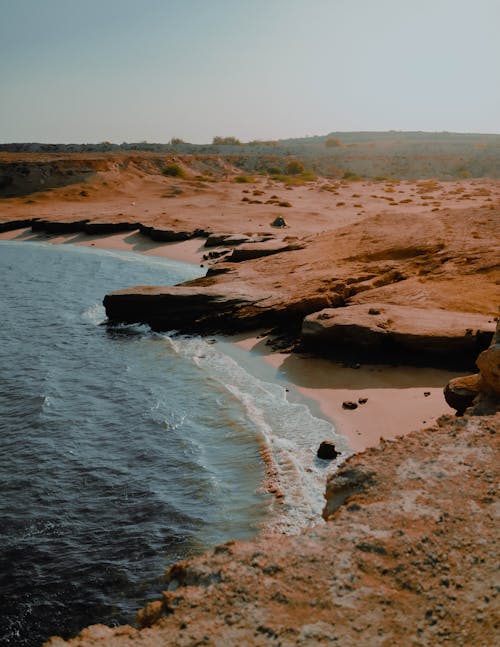 Rocky and Sandy Shore Near Body of Water