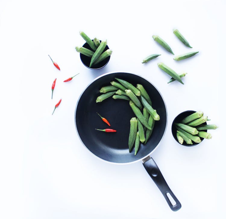 Okra And Red Chili On A Black Frying Pan