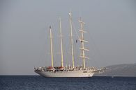 A grand sailing ship casts a majestic silhouette against the tranquil ocean waters, exuding elegance and maritime tradition.