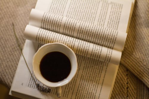 A Cup of Black Coffee on an Open Book