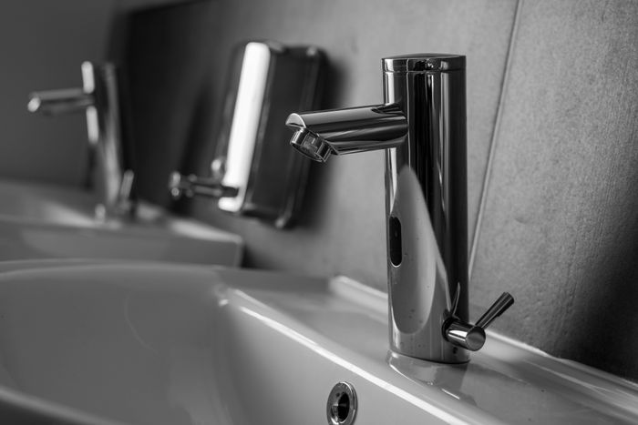 Stainless steel faucet on a white ceramic sink