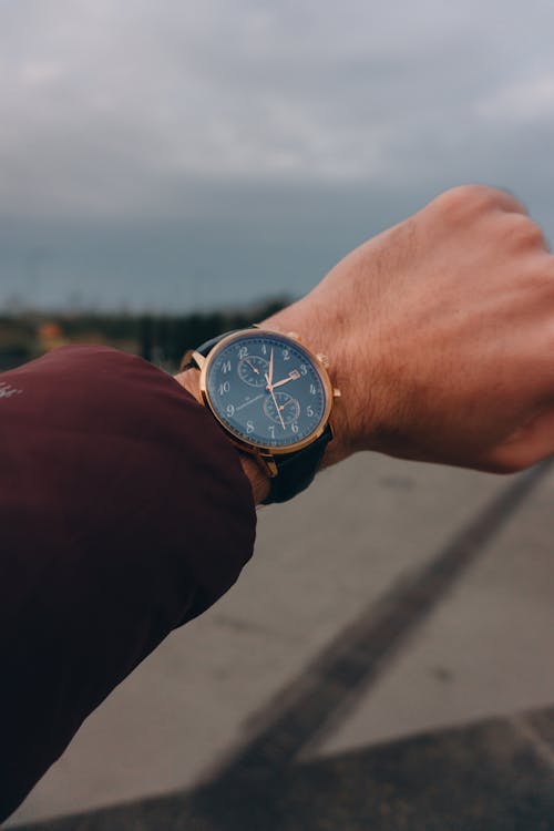 Free A Person Wearing Round Analog Watch Stock Photo