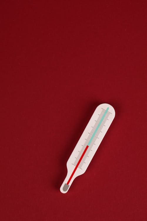 White Thermometer on Red Background