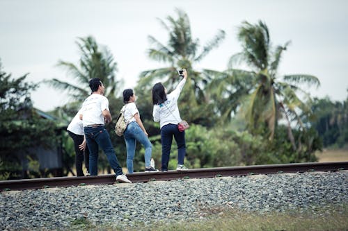 grátis Pessoa Fazendo Uma Selfie Com Três Pessoas Na Ferrovia Foto profissional