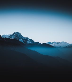 A breathtaking silhouette of the Swiss Alps under a twilight sky, capturing natural beauty in Switzerland.