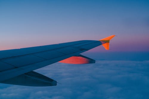 Free Airplane Wing Over White Clouds Stock Photo