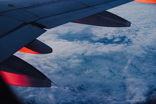 Free Airplane Above White Clouds Stock Photo