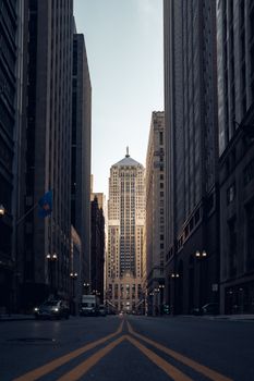 A view of Chicago's iconic skyscrapers from a ground level perspective at dawn.