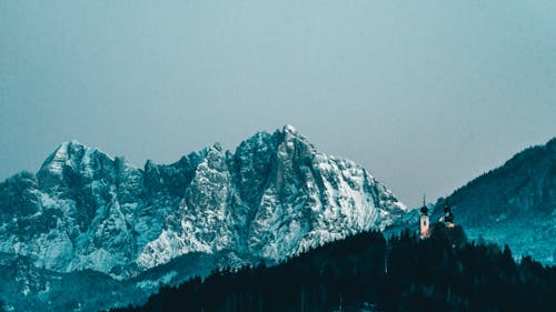 A Snow Covered Mountain Under Blue Sky