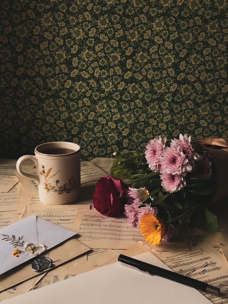 Music Sheets, Cup Of Tea And Flowers On A Table 