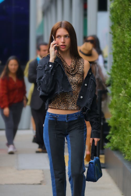 Stylish Woman Walking While on Phone Call