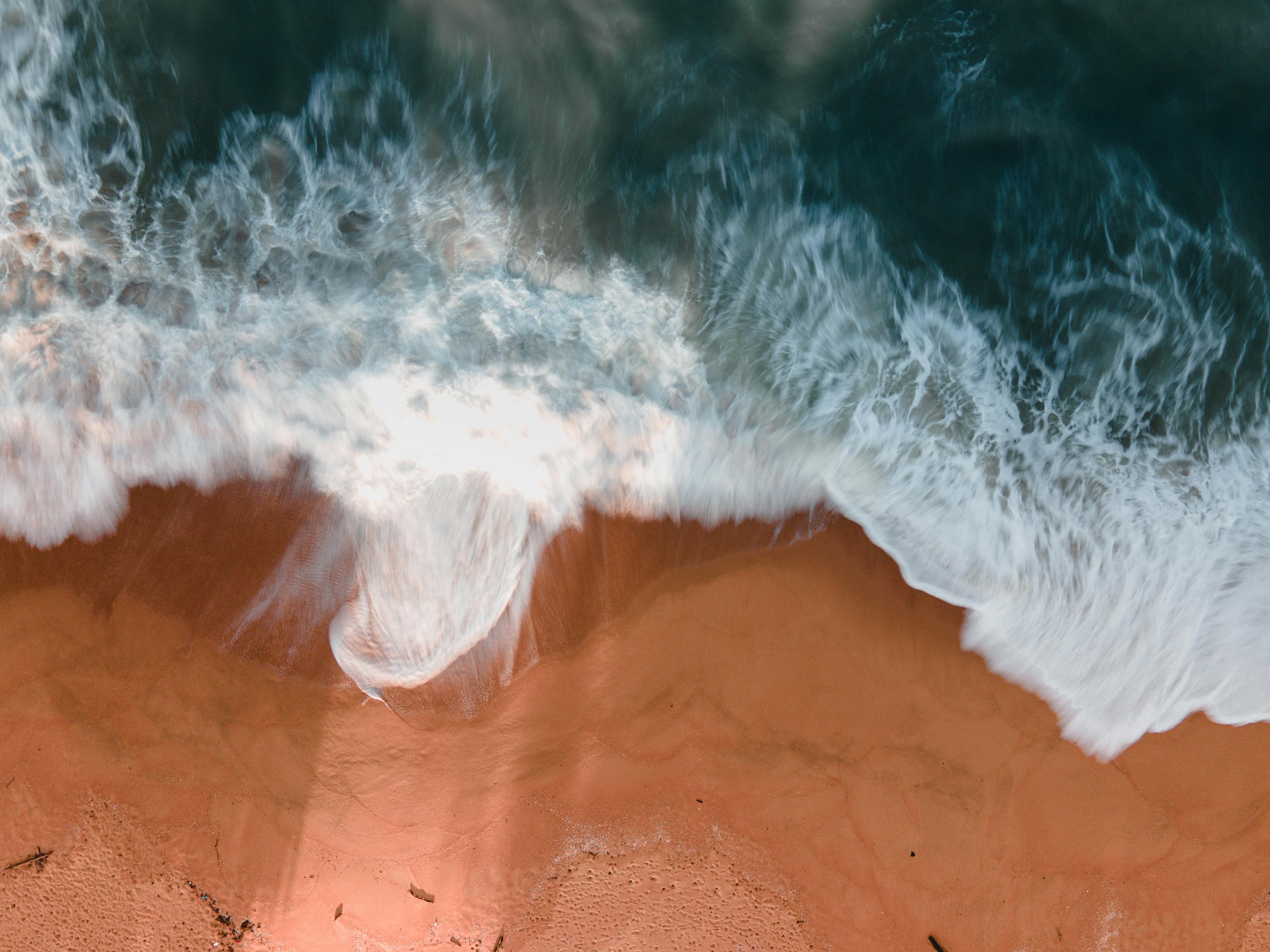 A Top View of Waves Crashing on a Shore · Free Stock Photo