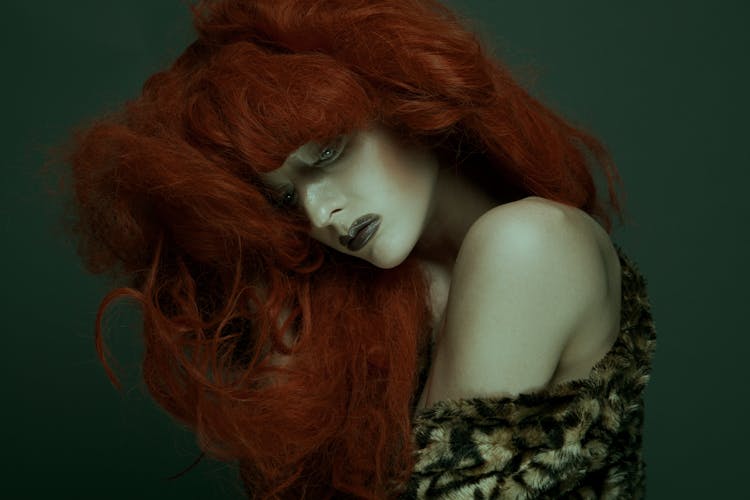 A Woman With Red Hair And Makeup