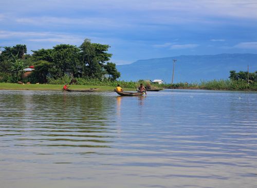 Free Two fishermen in a boat on a serene lake with a lush landscape in Sunamganj, Bangladesh. Stock Photo