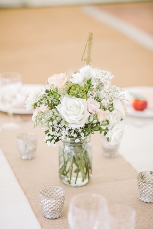 White Flowers on Clear Glass Mason Jar