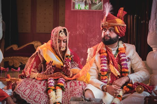 A Couple Sitting Together During the Ceremony