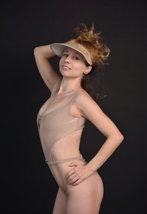 A Woman Modeling in a Swimsuit and a Sun Visor