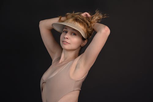 Woman in Brown Tank Top and Brown Hat