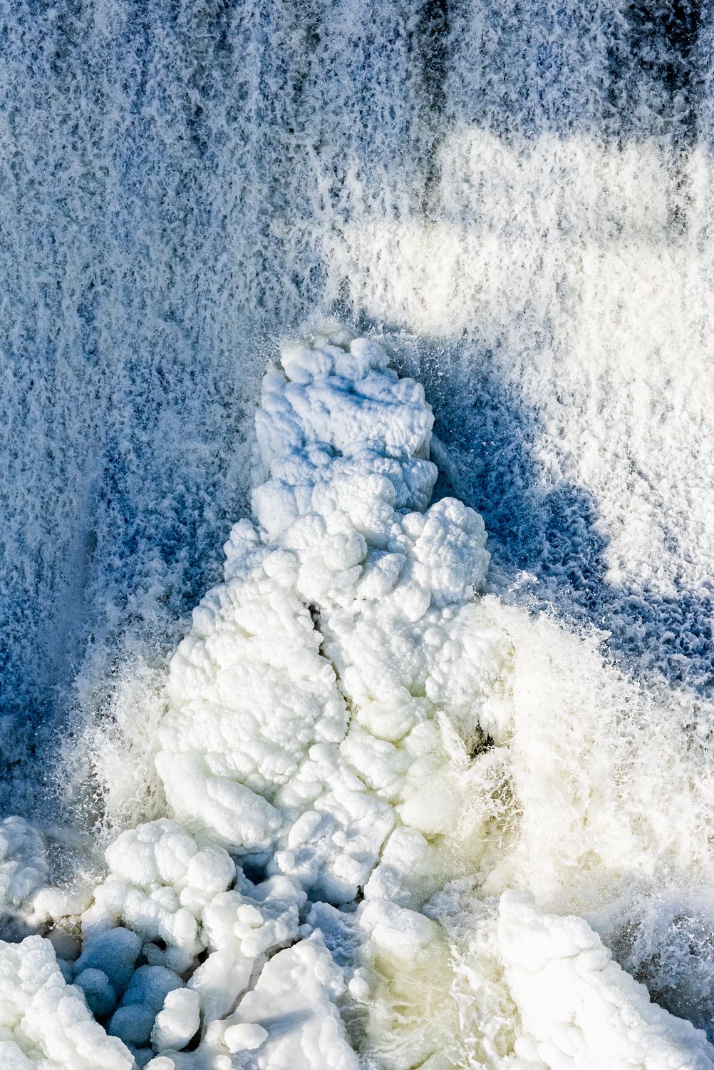 Frozen waterfall cascade in winter forest