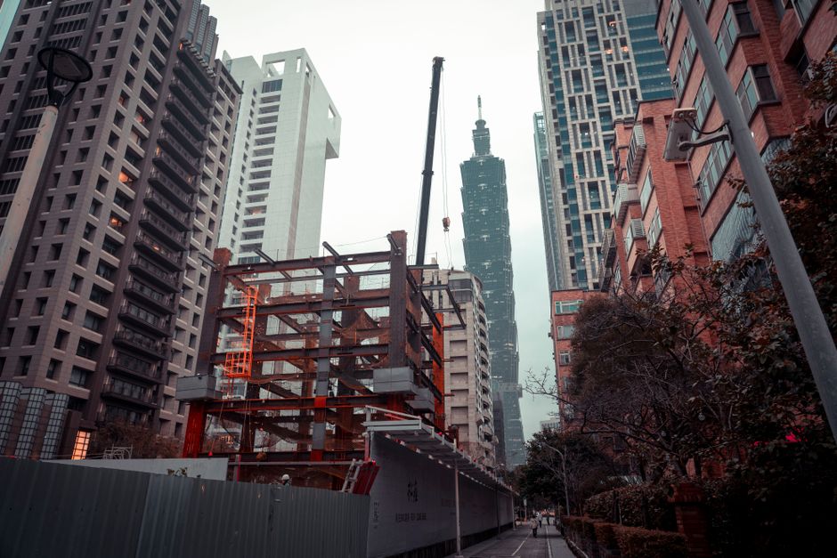 Dynamic cityscape featuring Taipei 101 and a construction site in Taipei, Taiwan.