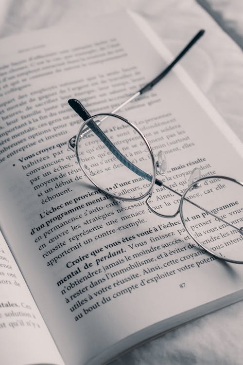 Eyeglasses on Book in Close Up Photography