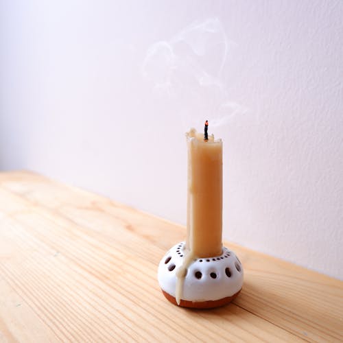 White Candle on Brown Wooden Table