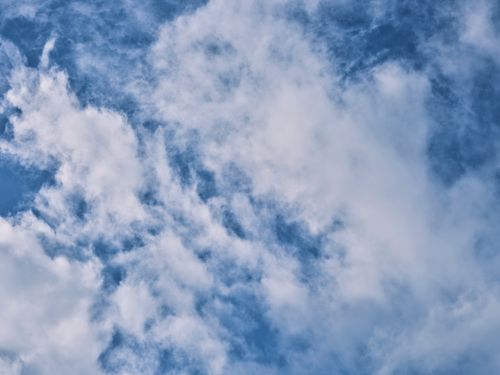 Free Clear blue sky with fluffy white clouds, perfect serene atmosphere. Stock Photo