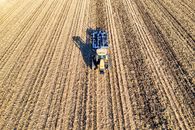 A Tractor on Brown Agricultural Land