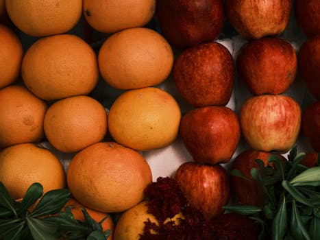 Vibrant still life of fresh grapefruits and apples, showcasing organic produce.