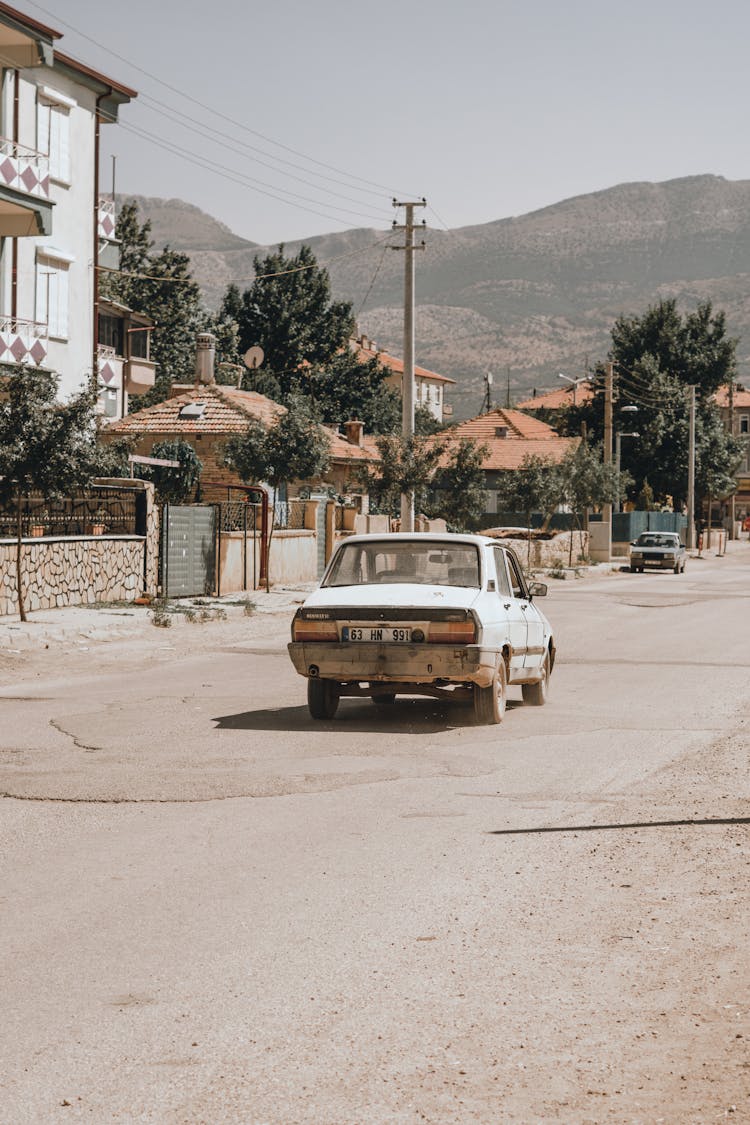 An Old Car On A Road