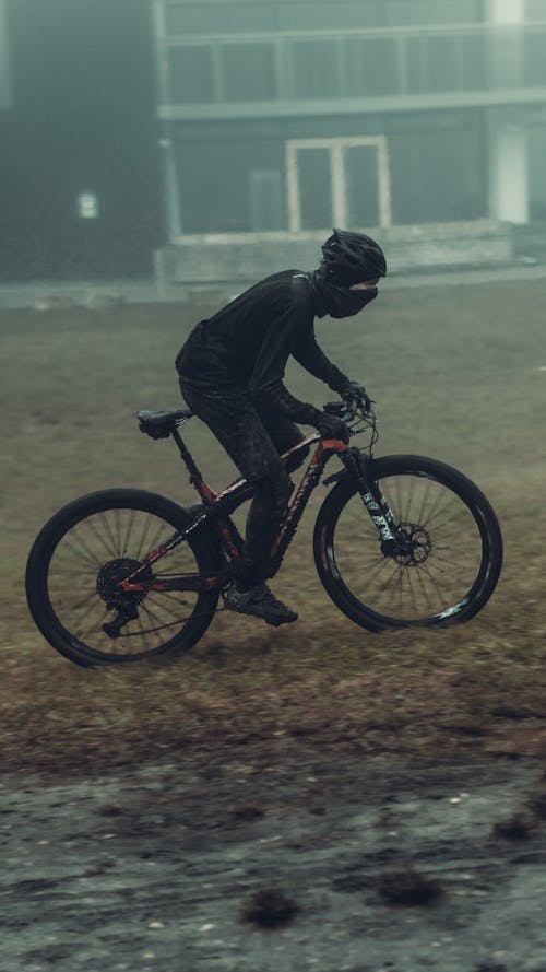 Person Riding Mountain Bike on Grass